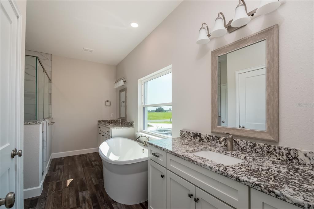 2073 Northwest 79th Loop Ocala, FL 34475 - Photo 34 of 75 a bathroom with a granite countertop sink a toilet and a mirror