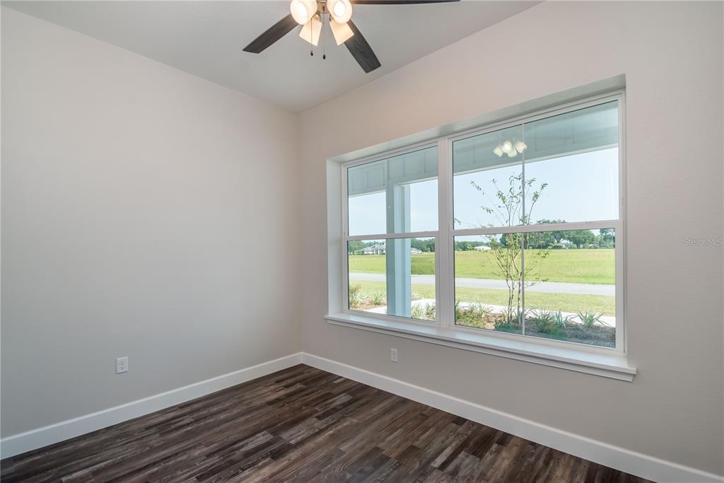 2073 Northwest 79th Loop Ocala, FL 34475 - Photo 42 of 75 a view of an empty room with a window and wooden floor