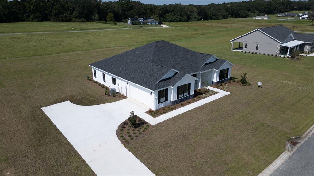 2073 Northwest 79th Loop Ocala, FL 34475 - Photo 72 of 75 an aerial view of a house with a yard