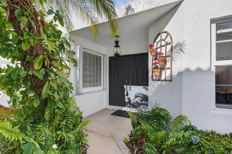 a front view of a house with plants