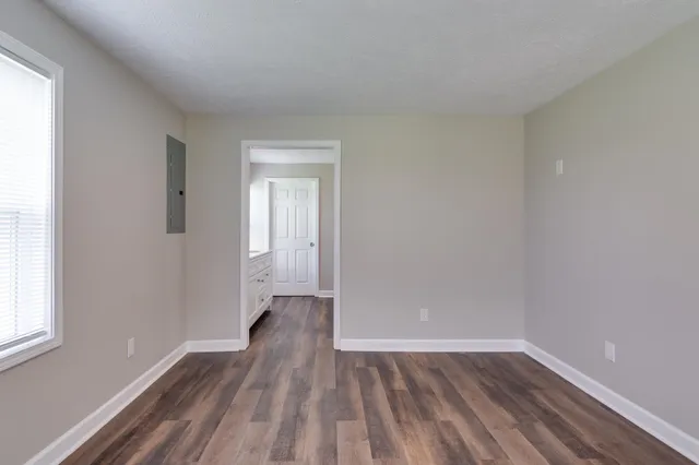 a bathroom with a granite countertop tub sink and mirror