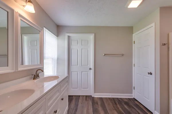 a bathroom with double vanity sink and a mirror