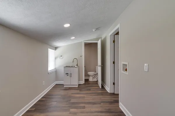 a view of a room with wooden floor and window