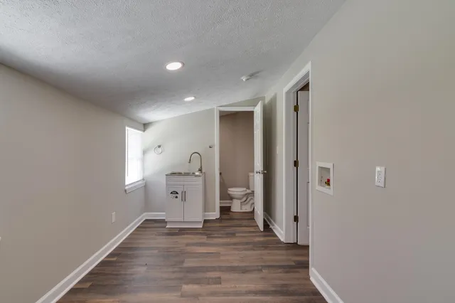 a view of a room with wooden floor and window
