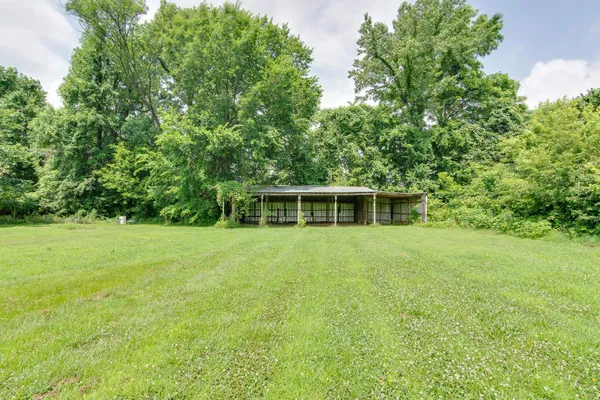 front view of a house with a yard and trees