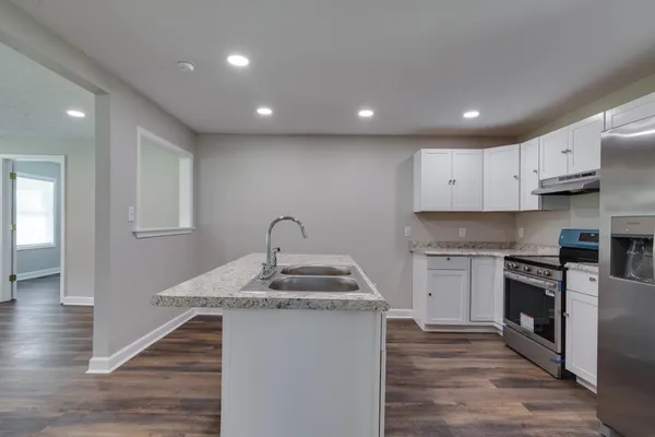 a kitchen with a stove and a refrigerator