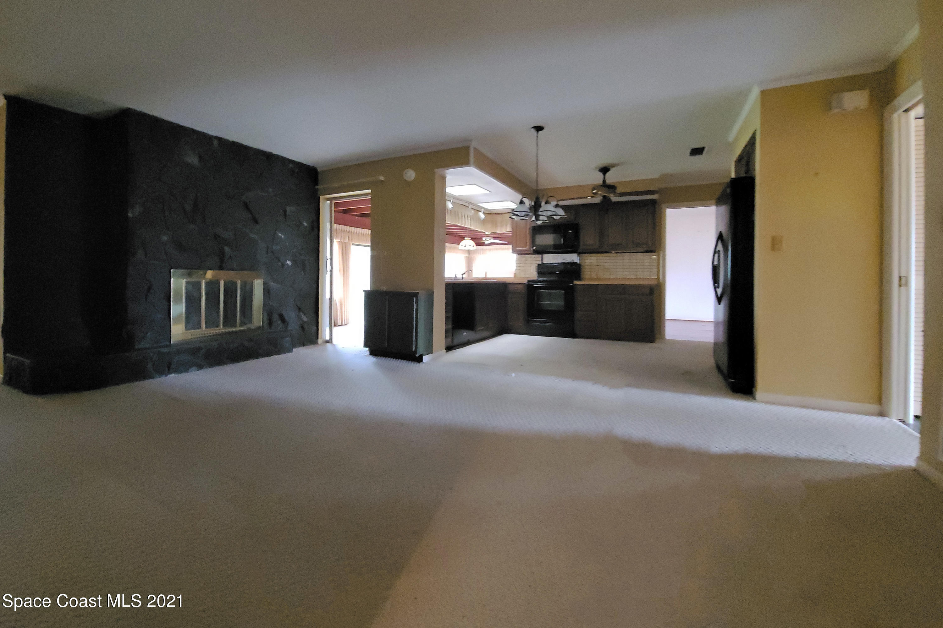 47 Country Club Road Cocoa Beach, FL 32931 - Photo 11 of 32 fireplace kitchen before