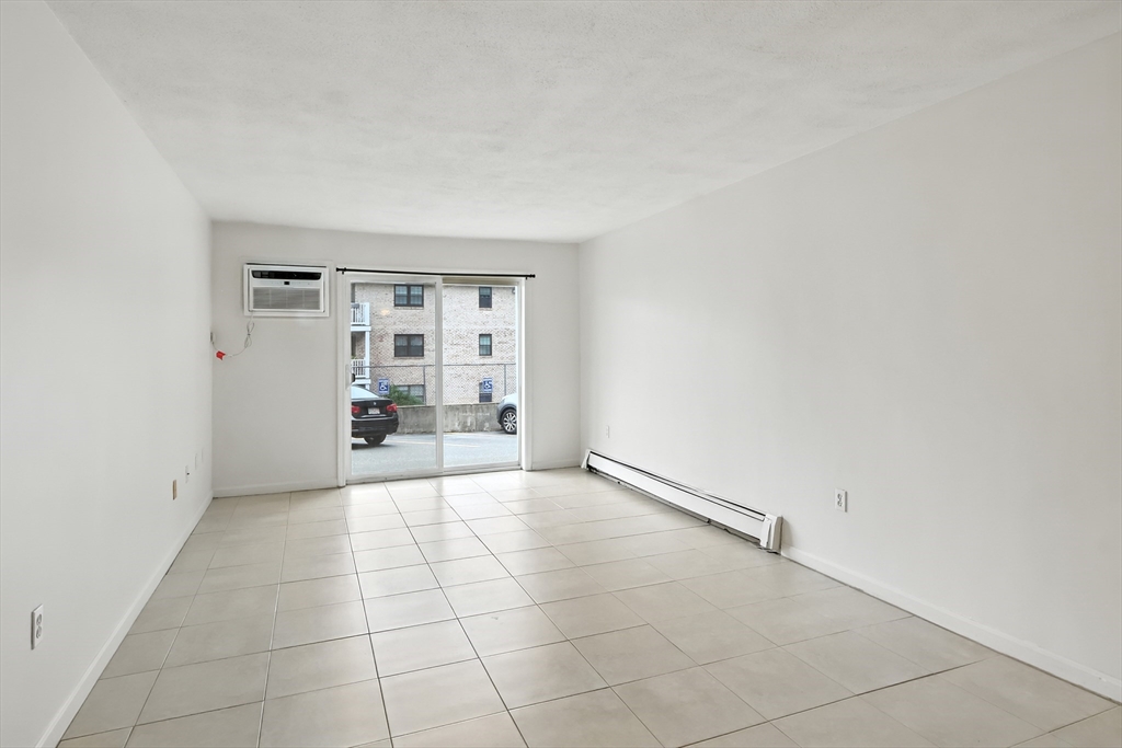 18 Kenmar Drive, Unit 149 Billerica, MA 01821 - Photo 4 of 13 an empty room with kitchen view