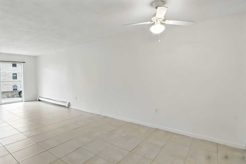 18 Kenmar Drive, Unit 149 Billerica, MA 01821 - Photo 5 of 13 an empty room with windows and ceiling fan