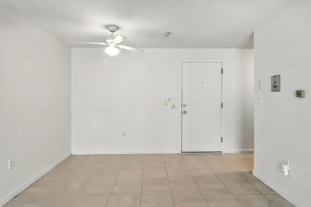 a kitchen with granite countertop white cabinets and a stove