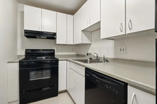 a kitchen with a sink and a refrigerator