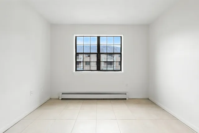 a view of an empty room and closet area