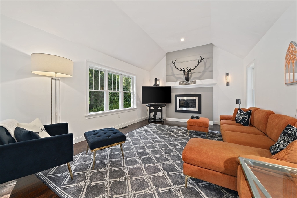 340 Old Oaken Bucket Road Norwell, MA 02061 - Photo 12 of 37 a living room with furniture a fireplace and a flat screen tv