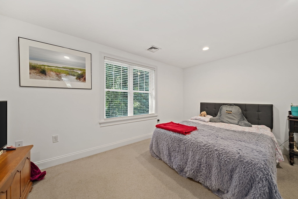340 Old Oaken Bucket Road Norwell, MA 02061 - Photo 23 of 37 a bed sitting in a bedroom next to a window
