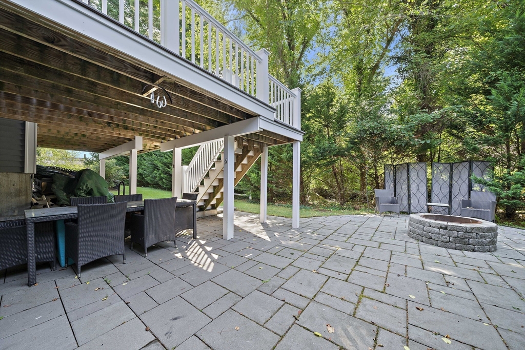 340 Old Oaken Bucket Road Norwell, MA 02061 - Photo 31 of 37 a view of a patio with table and chairs potted plants and large tree