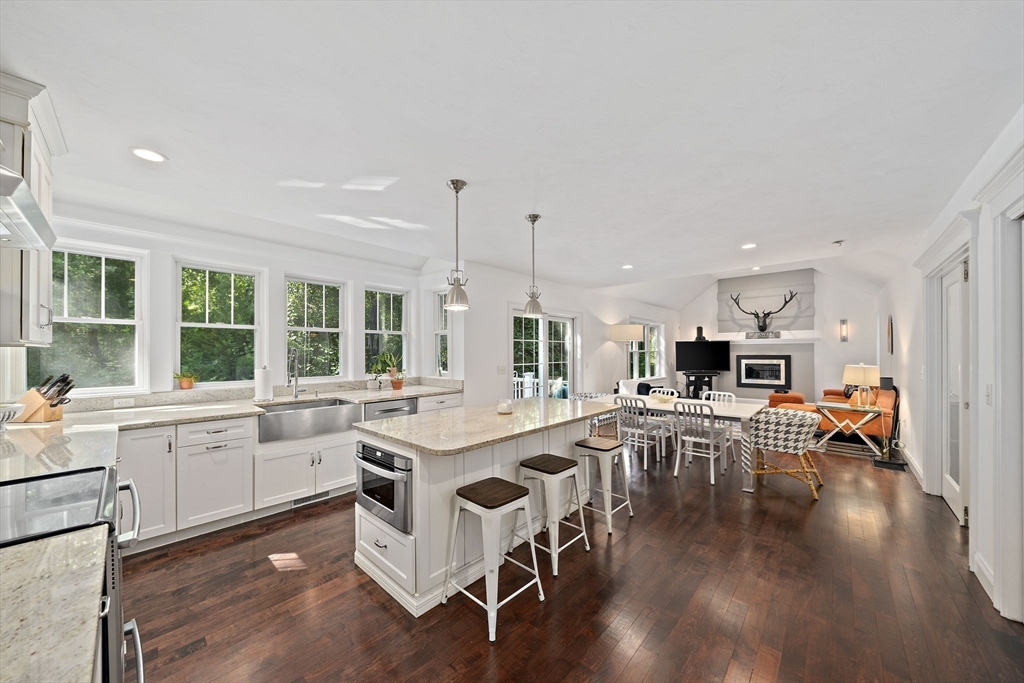 340 Old Oaken Bucket Road Norwell, MA 02061 - Photo 7 of 37 a kitchen with a table chairs stove and cabinets