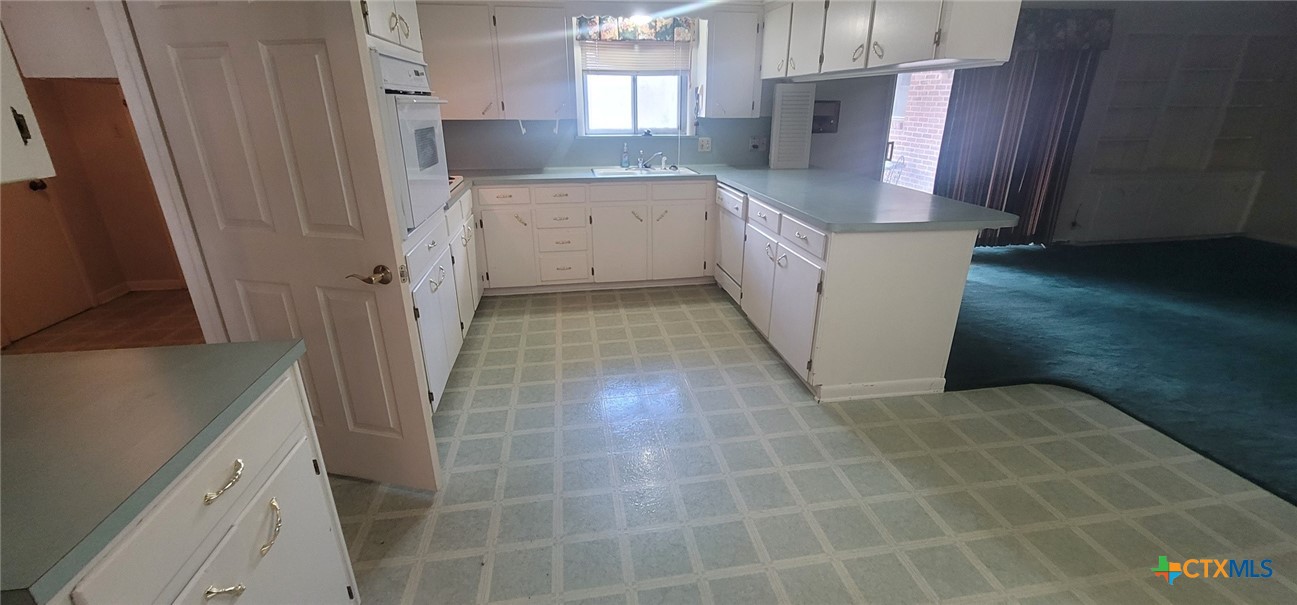 2602 College Drive Victoria, TX 77901 - Photo 17 of 29 a kitchen with a sink a stove and refrigerator