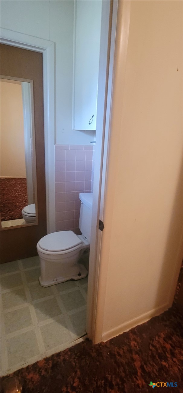 2602 College Drive Victoria, TX 77901 - Photo 9 of 29 a white toilet sitting next to a bathroom sink