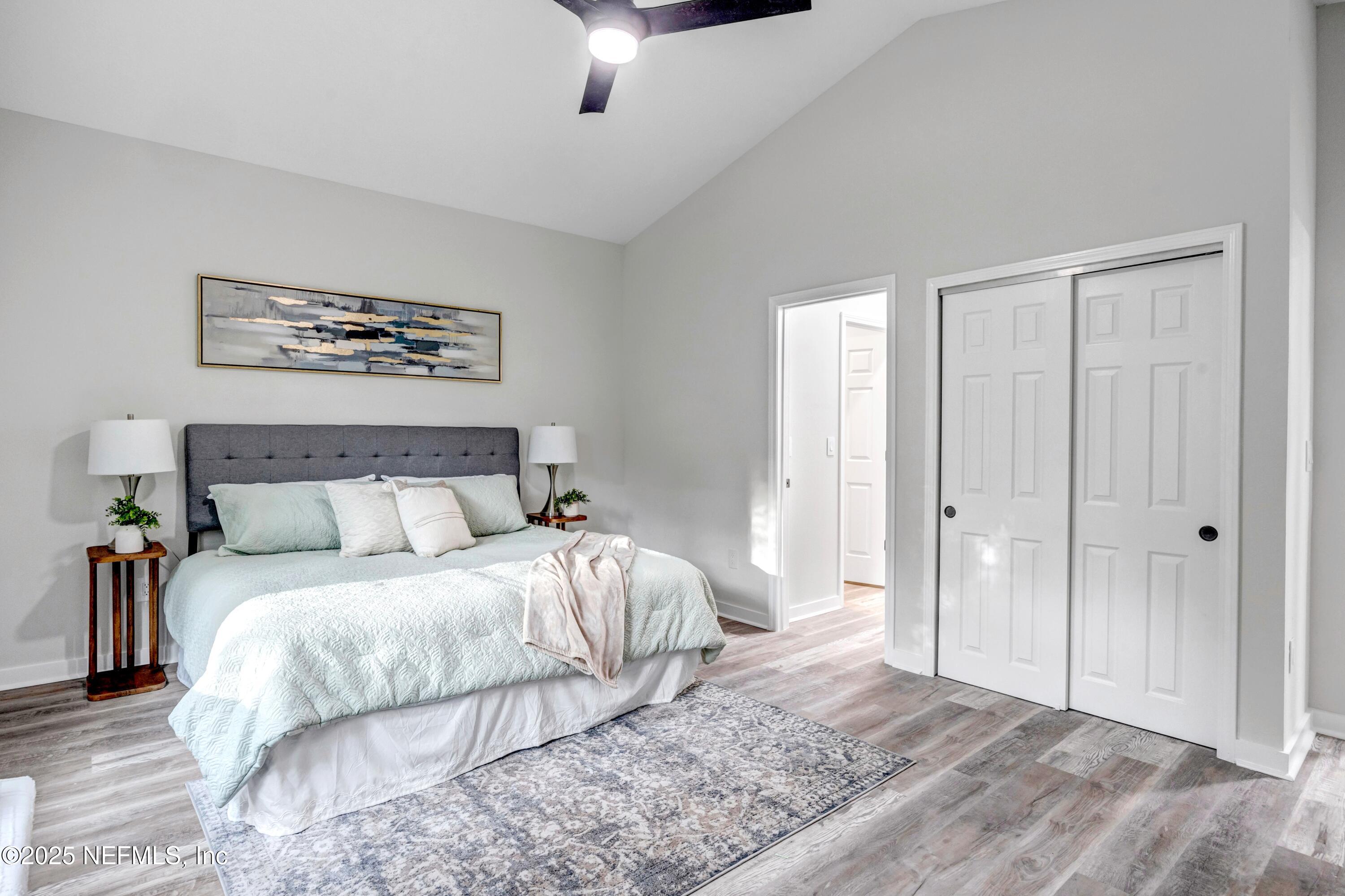 85 Delmonte Street Baldwin, FL 32234 - Photo 21 of 34 a bedroom with a large bed and a chandelier