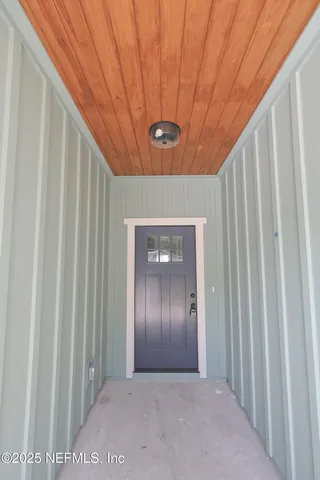 a kitchen with stainless steel appliances granite countertop stove a oven a dining table and chairs with wooden floor