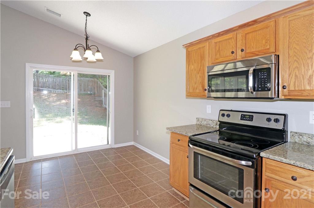 1509 Summit Ridge Lane Kannapolis, NC 28083 - Photo 12 of 37 a kitchen with granite countertop a stove top oven and a sink