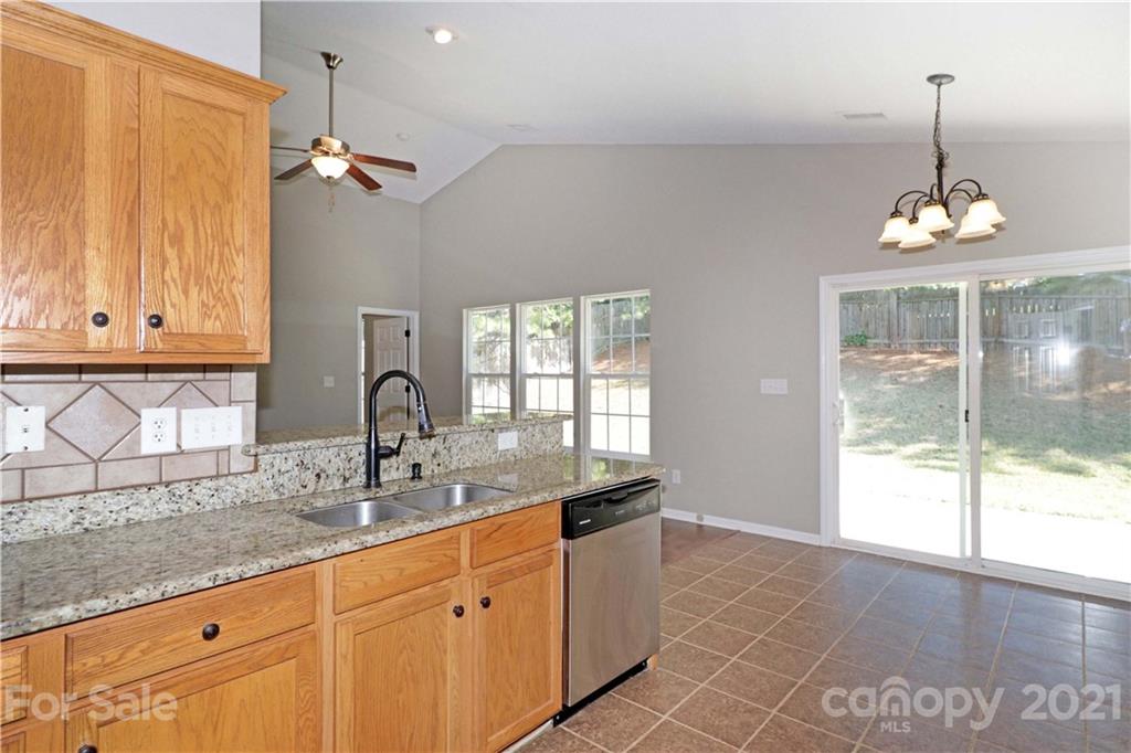 1509 Summit Ridge Lane Kannapolis, NC 28083 - Photo 13 of 37 a kitchen with granite countertop a sink and white cabinets