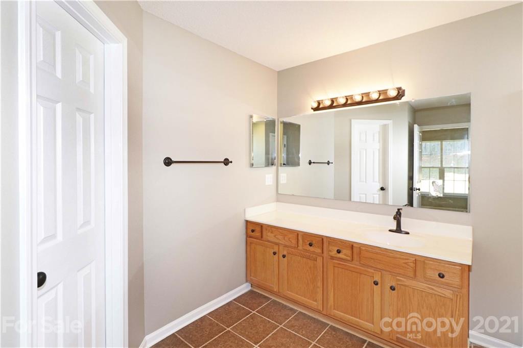 1509 Summit Ridge Lane Kannapolis, NC 28083 - Photo 20 of 37 a en suite bathroom with a sink and a mirror