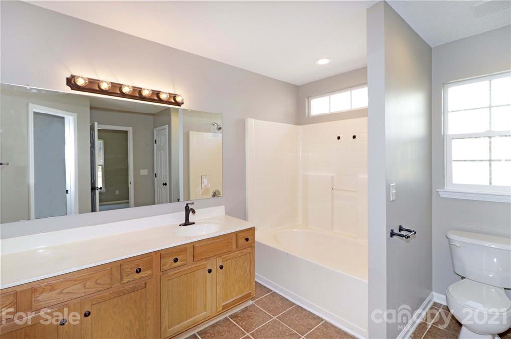 1509 Summit Ridge Lane Kannapolis, NC 28083 - Photo 21 of 37 a bathroom with a bathtub shower sink and a toilet