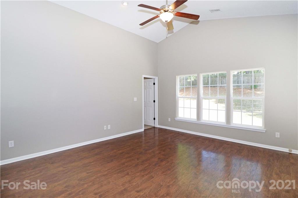 1509 Summit Ridge Lane Kannapolis, NC 28083 - Photo 7 of 37 an empty room with wooden floor fan and windows