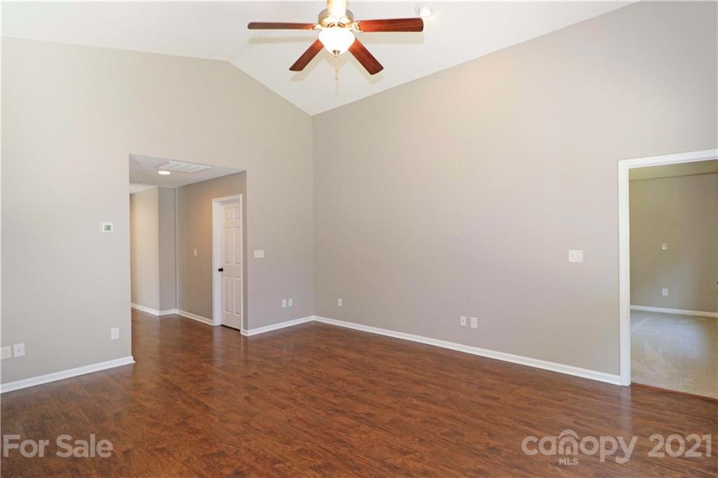 1509 Summit Ridge Lane Kannapolis, NC 28083 - Photo 8 of 37 an empty room with wooden floor and windows