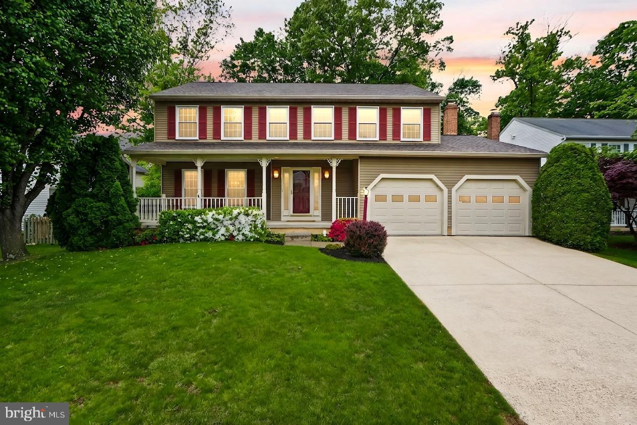 a front view of a house with a garden and plants