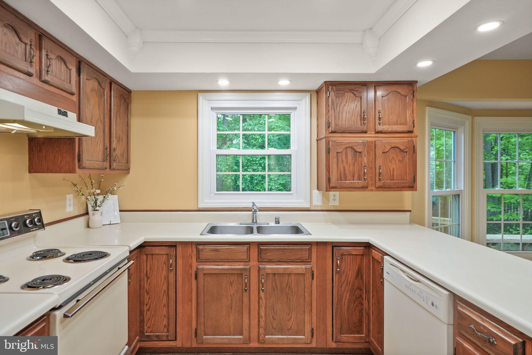 169 Applegate Drive Sterling, VA 20164 - Photo 18 of 55 a kitchen with granite countertop a sink stove and cabinets