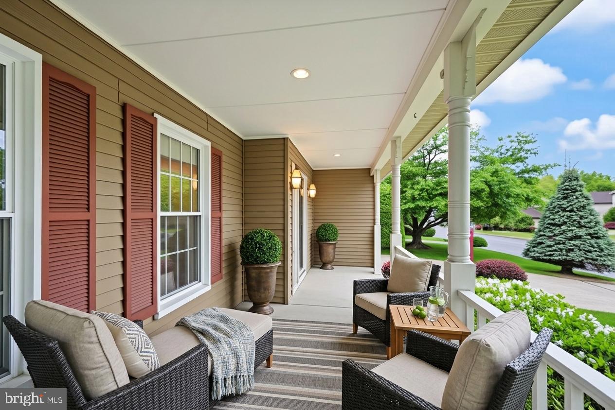 169 Applegate Drive Sterling, VA 20164 - Photo 4 of 55 a view of a patio with couches chairs potted plants and floor to ceiling window and potted plants