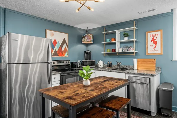 a kitchen with a table and chairs in it