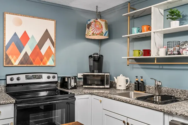 a kitchen with a stove and a microwave