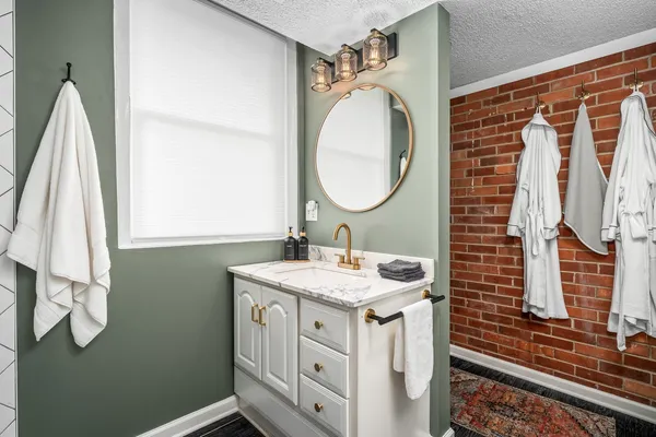a bathroom with a sink a vanity and a mirror