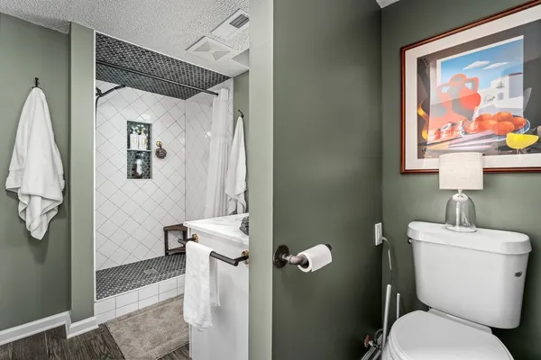 a white toilet sitting next to a bathroom sink
