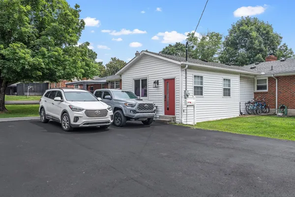 a view of a house and car parked in front of house