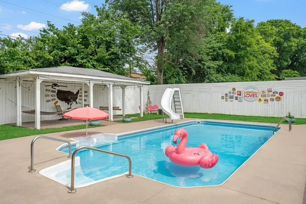 a view of a backyard with a table and chairs