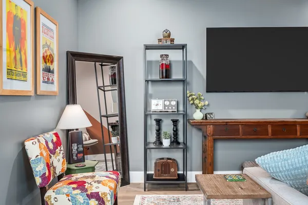 a living room with furniture a rug and a flat screen tv