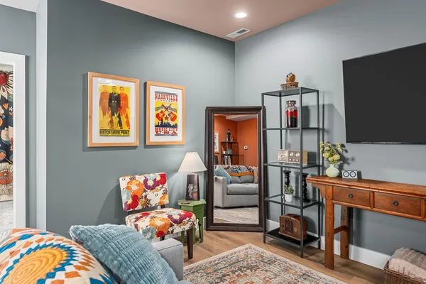 a bedroom with furniture and a flat screen tv