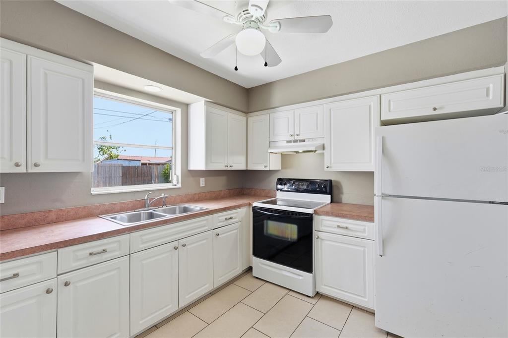 363 Glen Oak Road Venice, FL 34293 - Photo 21 of 53 a kitchen with white cabinets and white appliances