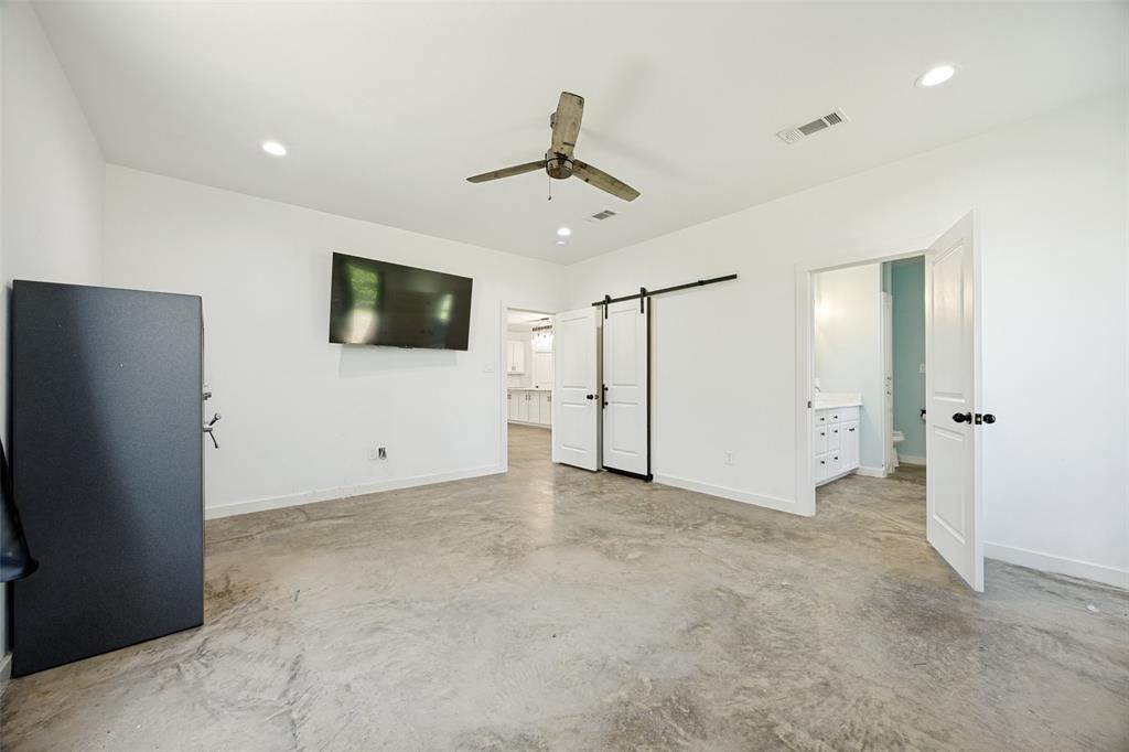 822 Private Road 7370 Point, TX 75472 - Photo 20 of 30 Spacious room featuring concrete flooring, a ceiling fan with integrated lighting, recessed lighting, and a white barn door entry
