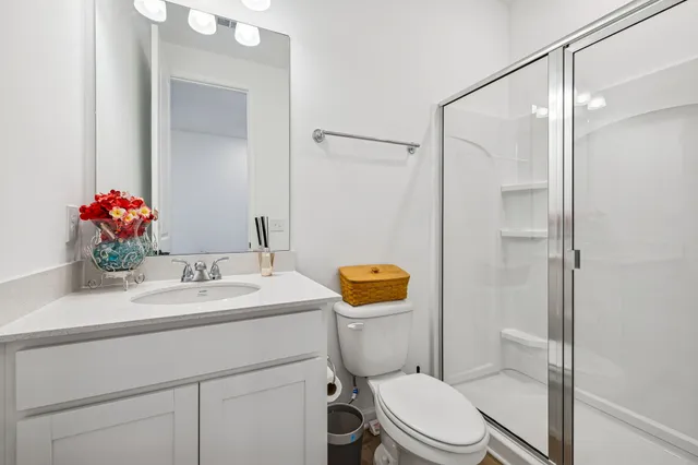 a large kitchen with sink a counter top space and living room view