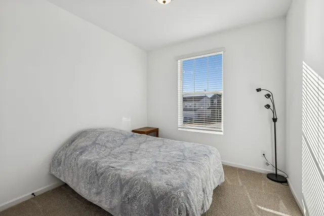 a kitchen with stainless steel appliances kitchen island granite countertop a table chairs sink and cabinets