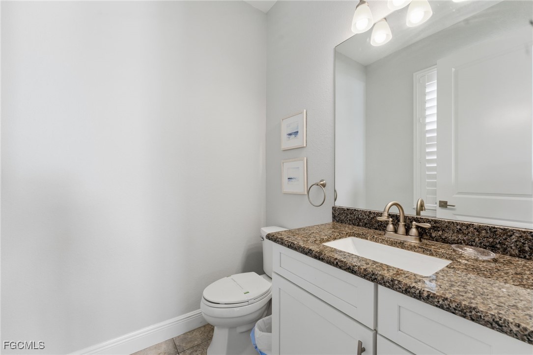12304 Boat Shell Drive Matlacha Isles, FL 33991 - Photo 22 of 49 a bathroom with a granite countertop sink and a mirror