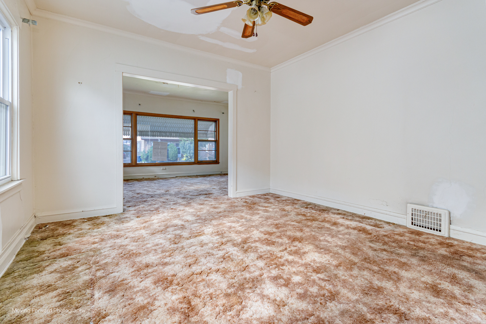 643 South 19th Avenue Maywood, IL 60153 - Photo 18 of 41 en empty room with a fireplace and chandelier