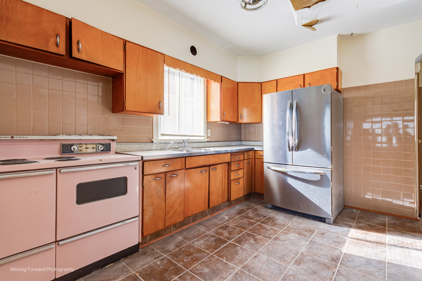 643 South 19th Avenue Maywood, IL 60153 - Photo 23 of 41 a kitchen with stainless steel appliances granite countertop a stove a sink and a refrigerator
