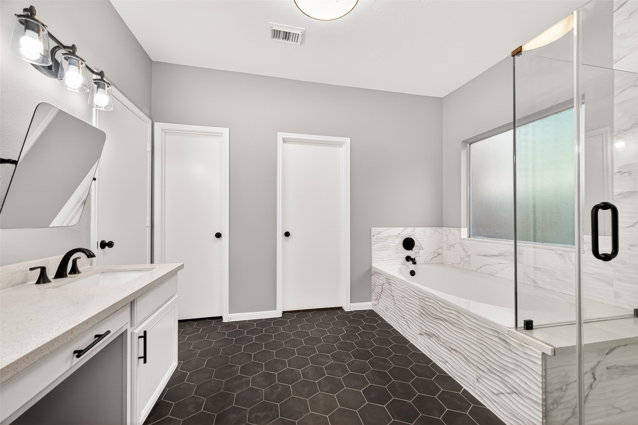 23810 Spring Way Drive Spring, TX 77373 - Photo 19 of 35 a spacious bathroom with a double vanity sink a mirror and a bathtub