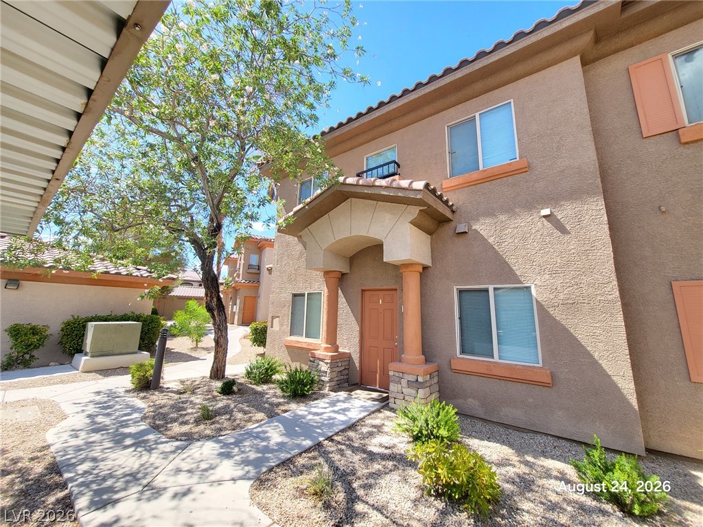 7701 West Robindale Road, Unit 125 Las Vegas, NV 89113 - Photo 1 of 16 Stucco exteriors and a covered entry frame the front of this multi-level residence.
